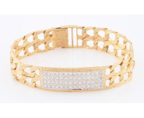 SOLD WITHOUT BUYERS PREMIUM AND VAT. A yellow metal double curb link bracelet, the central panel set with four rows of round 