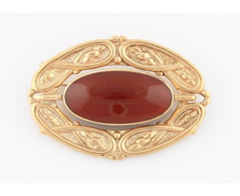 SOLD WITHOUT BUYERS PREMIUM AND VAT. A 9ct yellow gold rotating Celtic design brooch, the central panel having one side set w