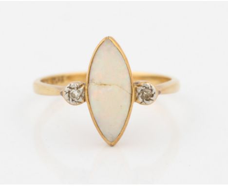 An opal and diamond ring, set with a central marquise shaped opal cabochon, flanked to either side with an eight-cut diamond,