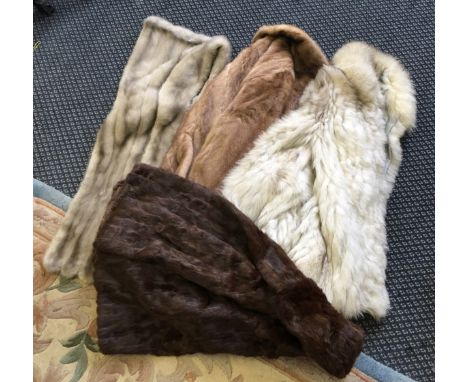 Three fur coats and a fur wrap, in assorted light and dark colour.