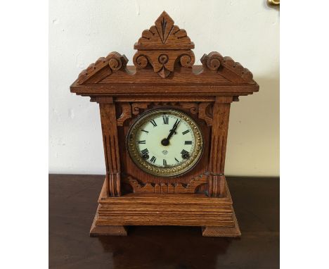 A mid 20th Century mantel clock with craved oak body.
