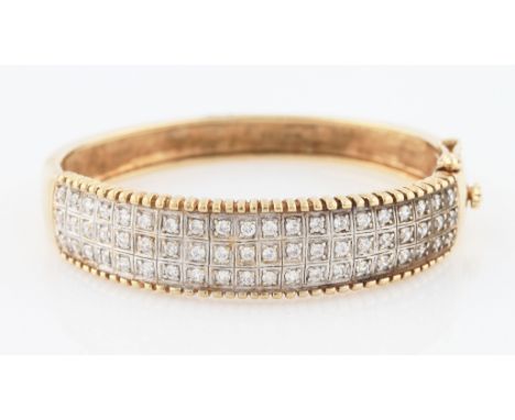 SOLD WITHOUT BUYERS PREMIUM AND VAT. A 9ct yellow gold cubic zirconia hinged bangle, half bangle set with three rows of round