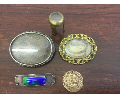 A lot to include an gold plated memorial brooch, containing hairwork, a white metal memorial brooch, containing weaved hairwo