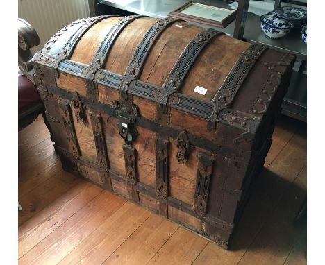 A 19th Century dome topped travel trunk with metal decorations and fittings with fitted lid interior.
