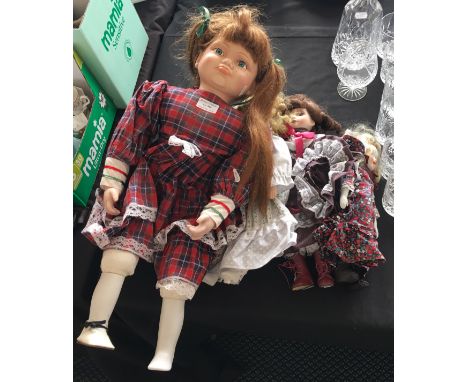 Four modern ceramic head dolls of assorted sizes.