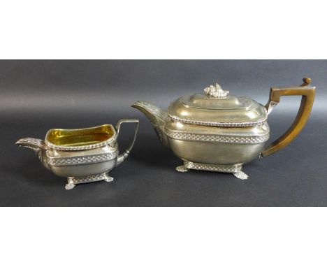 A George III silver teapot and matching milk jug, of London shape with basket weave and stiff leaf borders, the hinged lid wi