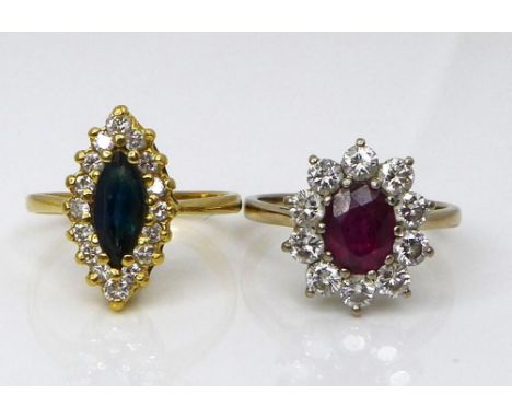 Two 18ct gold dress rings, one set with a central oval cut ruby of approximately 7 by 5.7mm, surrounded by ten diamonds, size