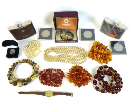 A collection of amber and costume jewellery including a necklace of rough cut butterscotch amber a further honey coloured amb