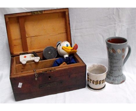 A pine box containing a Donald Duck Pelham puppet,a west country motto ware jug and other items 