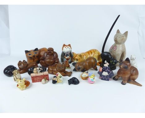 A large collection of figures of cats, including carved Oriental examples, ceramic examples and others.