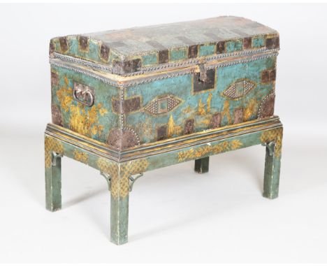 An 18th century lacquered leather green chinoiserie trunk, the domed lid and sides with studded and metal bounded edges, rais