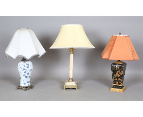 A modern Italian porcelain and brass mounted table lamp, painted with blue and yellow fruiting vines against a white baluster