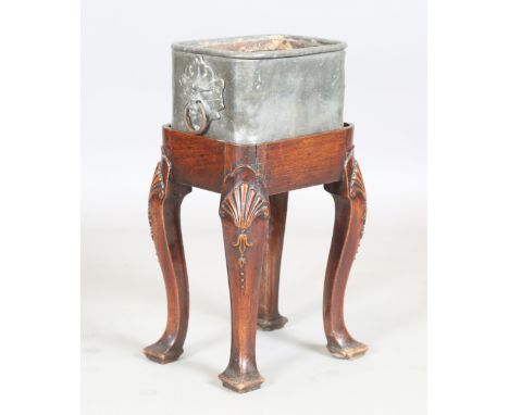 A George II red walnut stand, the top fitted with a lead planter, the deep plain frieze raised on finely carved cabriole legs