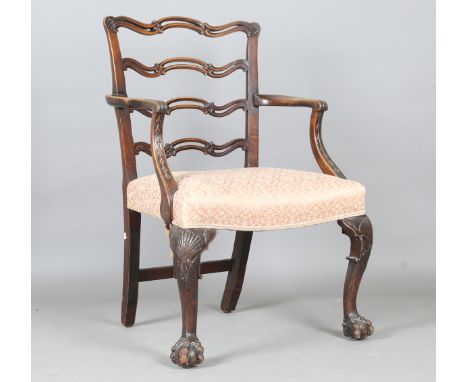 An early 20th century Chippendale style mahogany pierced ladder back elbow chair, the cabriole legs carved with scallop shell