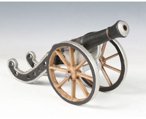 An early 20th century cast iron scale model of a cannon with later painted decoration, width 35cm.Buyer’s Premium 29.4% (incl