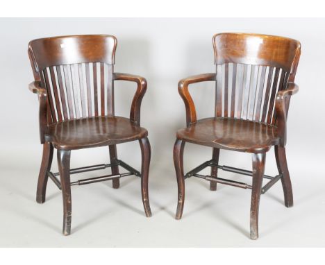 A near pair of early 20th century mahogany and stained beech comb back office chairs, height 87cm, width 56cm, depth 46cm.Buy