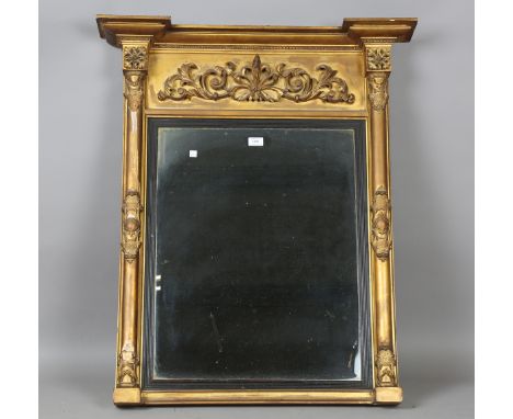 An early 19th century giltwood pier mirror with a carved foliate frieze and foliate cartouche-decorated pilasters, the revers