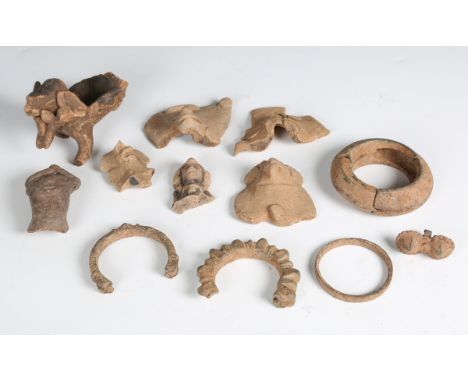 A group of archaeological pottery fragments, probably Indian, and a group of similar metal bangle fragments.Buyer’s Premium 2