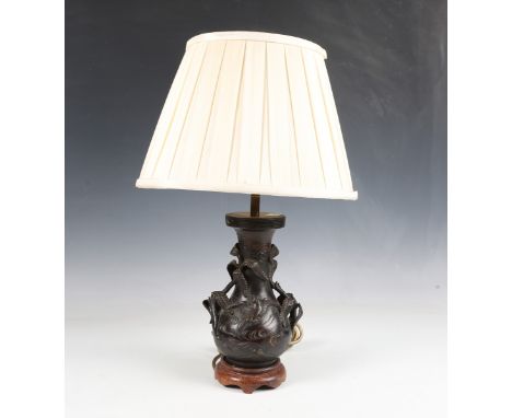 A Japanese bronze vase, Meiji period, ornately cast with flora and fauna, converted to a table lamp and fitted with a cream s