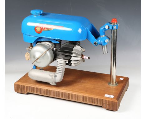A mid-20th century Mini-Motor gearless cycle outboard engine, mounted on a wooden plinth, width 51cm.Buyer’s Premium 29.4% (i