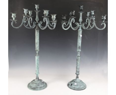 A pair of modern verdigris patinated metal nine-light candelabra, height 73cm.Buyer’s Premium 29.4% (including VAT @ 20%) of 