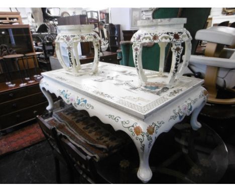 An oriental coffee table plus two stools