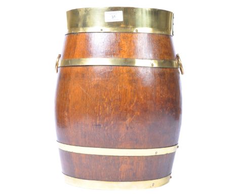 A 19th Century English antique oak stick / umbrella stand coopered barrel. Oval form with brass banded decoration having ring