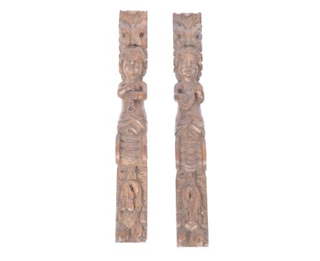 A pair of 19th century carved walnut architectural panels in the form of cherub / putti musicians. Each carved into relief wi