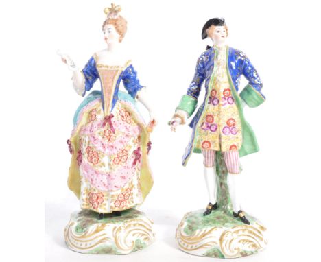 A pair of 19th Century antique porcelain figurines depicting a dandy gent and a lady. The man holding flower with cobalt and 