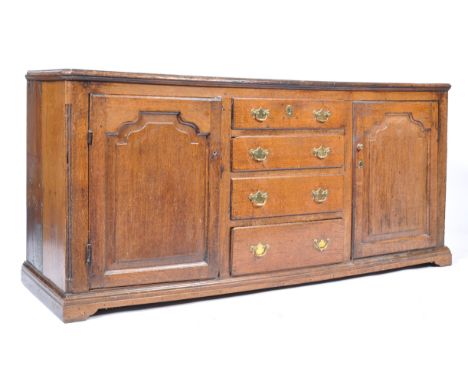 A good late 18th / early 19th century English country oak dresser base being raised on bracket feet having a central bank of 
