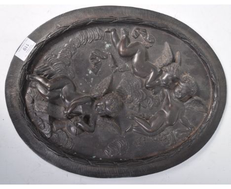 A 19th Century antique Grand Tour bronze plaque of oval form having relief decoration depicting Cherubs in flight among cloud