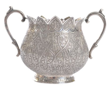 A late 19th Century Indian antique silver Kashmir / Kashmiri style prayer bowl. Scrolled twin handles to side with pointed fl