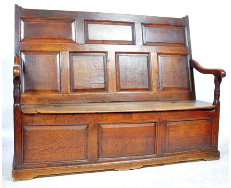 An 18th Century Georgian English antique oak Ecclesiastical monks / hall settle bench having a seven panel moulded high backr