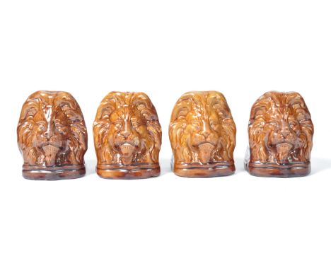 A set of four 19th Century English antique ceramic Sash window stays in the form of lion heads having a treacle glaze finish 
