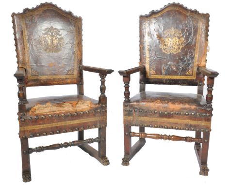 A pair of believed 18th century Italian leather and walnut Baronial court chairs. Each with stunning leather seat and back re