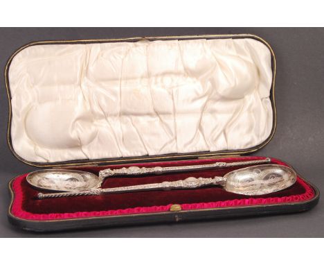 A fine pair of antique early 20th century Victorian hallmarked silver anointing spoons. The bowls beautifully shaped into the