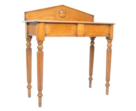 A 19th Century Victorian English antique oak console hall table having an arched gallery back with armorial crest over table 