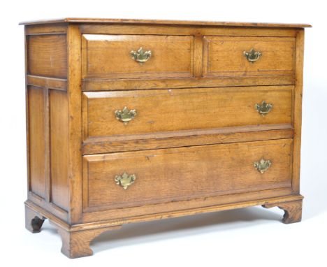 An early 19th Century Georgian English antique oak chest of drawers of good proportions. The bank of two over two drawers hav
