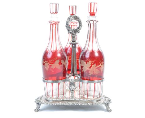 A set of x3 19th century Victorian ruby glass Bohemian decanters having an acid etched decoration of grape bunches and vines 