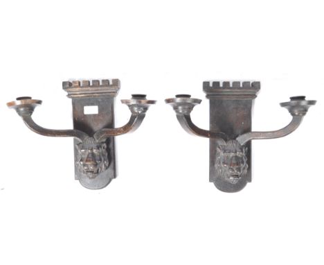 A pair of 19th Century antique carved oak wall sconces in the manner of Pugin having battlement tower back plates with carved