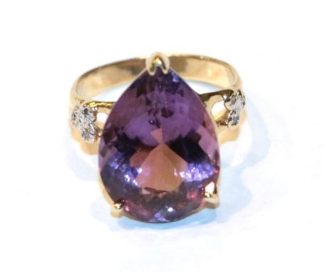 A pear shaped amethyst solitaire ring with diamond set shoulders, finger size I1/2.  Gross weight 3.6 grams. 