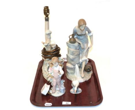 A Lladro figural table lamp, Lladro figure of a child, Lladro figure of a swan, Nao figure of a maiden (4)