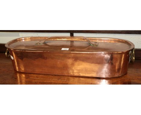 A copper fish kettle of oval form with two drop-ring loop handles, with conforming pull off cover