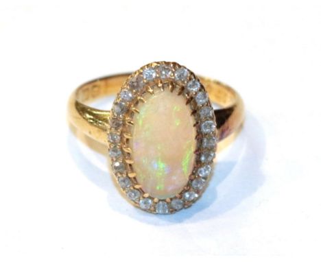 An 18 carat gold opal and diamond cluster ring, finger size K1/2.  Gross weight 4.6 grams. 