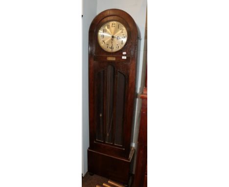 An Art Deco quarter chiming longcase clock, oak veneered case with arched pediment and an applied presentation plaque to the 