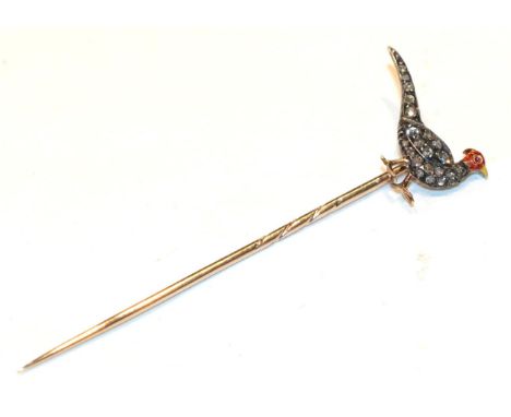 A stick pin, modelled as a pheasant with a red and yellow enamelled head with a cabochon ruby eye and set throughout with old