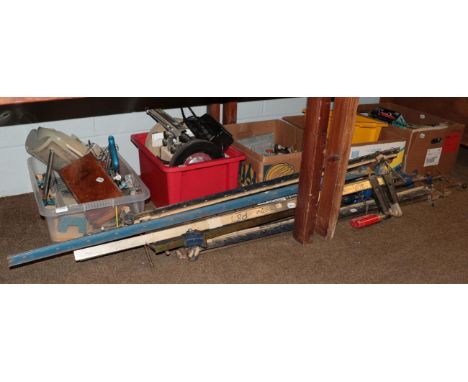 A quantity of various wood working tools, sash clamps, slow speed grind sharpener, a small quantity of car badges and manuals