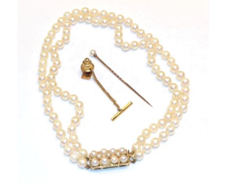 A double row cultured pearl necklace, clasp stamped '9CT'; a tie stud; and a cutlured pearl stick pin 