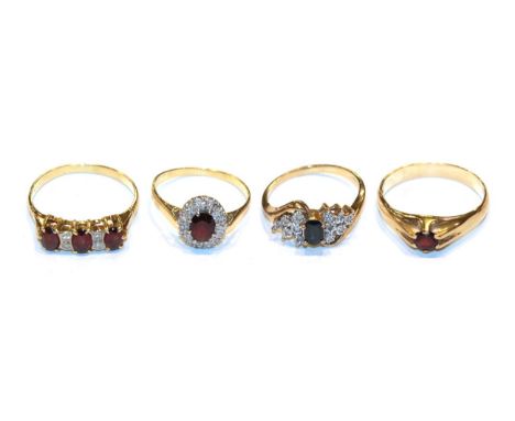 A 9 carat gold garnet solitaire ring, finger size X1/2; a garnet and diamond cluster ring, stamped '18CT', finger size T; a 9