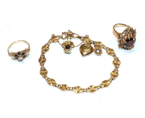 A 9 carat gold garnet solitaire ring, finger size N1/2; a 9 carat gold dress ring, finger size L; and a fancy link bracelet s